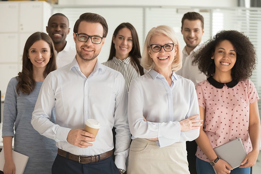 About OSBA - Portrait of Smiling Group of Teachers and Administrative Leaders in a Faculty Room