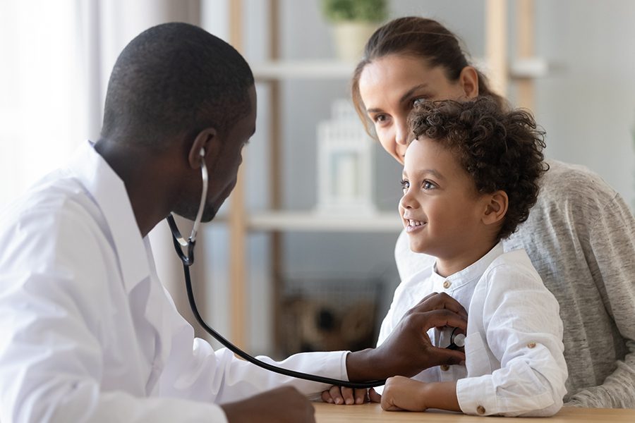 Employee Benefits - Pediatrician Listening to Child’s Lung and Heart Sounds During an Office Checkup
